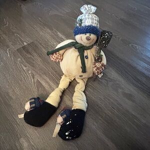 Plush sitting snowman with Shovel